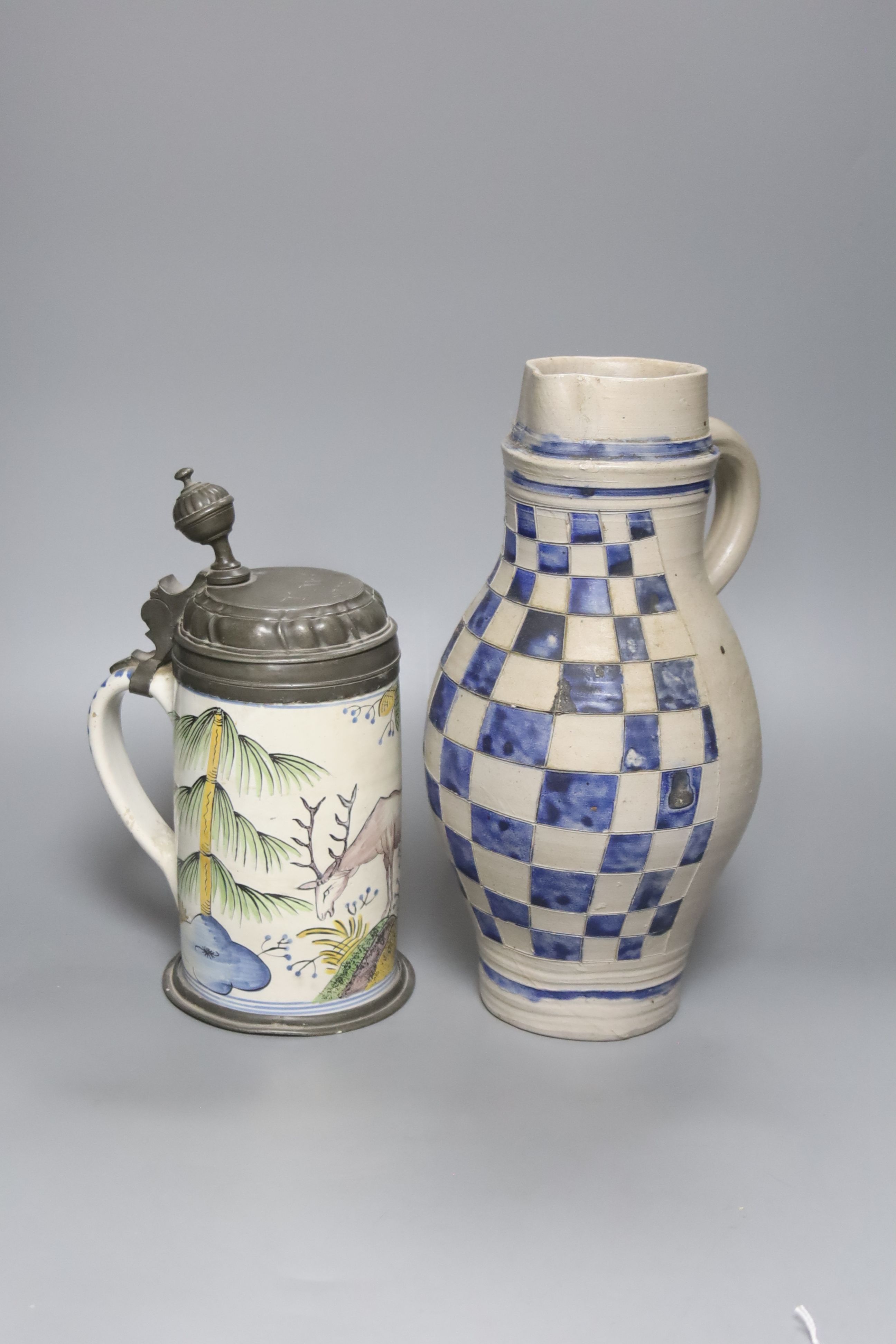 An 18th/19th century German faience pewter-mounted stein decorated with a stag and a German stoneware pitcher, height 25cm & 30cm